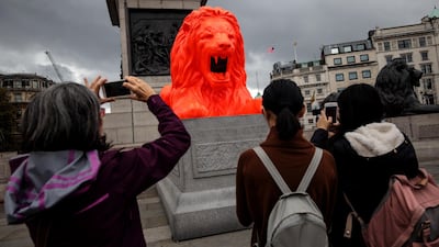 An installation featuring a bright red lion titled 'Please Feed The Lions' by British designer Es Devlin sits at the base of Nelson's Column in Trafalgar Square in London, England. Getty Images