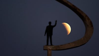 A statue of Brazil's former President Juscelino Kubitschek, founder of Brasilia, stands during a partial lunar eclipse in the skies over Brasilia, Brazil. AP Photo/Eraldo Peres
