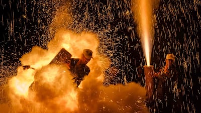 Men holding their handmade Tezutsu hanabi . AFP