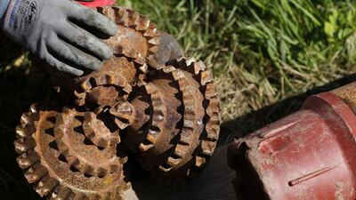 An employee holds a drill bit at the oil drilling site of the Millenium Geo-Venture company in Soufflenheim. Vincent Kessler / Reuters