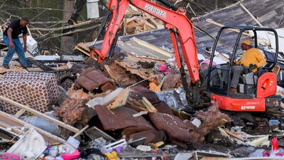 Residents look through a destroyed home in Amory. EPA