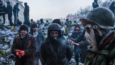 Anti-government protesters gather along barricades on Hrushevskoho Street. Brendan Hoffman / Getty Images
