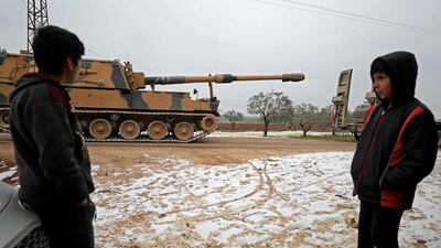 Children gaze at a Turkish 155mm self-propelled artillery gun in the town of Binnish in Syria’s northwestern province of Idlib, near the Syria-Turkey border. AFP