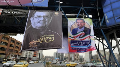 Iranians drive their cars past electoral posters and fliers during the last day of election campaign in the capital Tehran. AFP