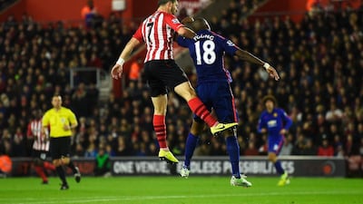 Shane Long of Southampton jumps for a header with Ashley Young of Manchester United during their Premier League match on Monday night. Mike Hewitt / Getty Images