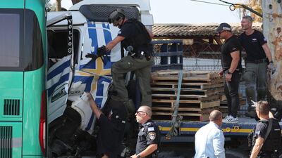 Law enforcement officials inspect the lorry in the Glilot suburb of Tel Aviv. AFP