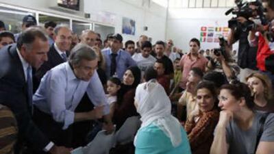 The United Nations High Commissioner for Refugees chief, Antonio Guterres, meets refugees during a visit to the organisation's head office in Duma, 20 km north of Damascus.