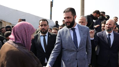 Syria's President Ahmad Al Shara visiting a camp in Idlib sheltering people displaced by the country's civil war, on Saturday. AFP