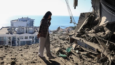A woman stands in the shell an apartment after the building was hit in a Russian drone strike, in Odesa, Ukraine. Reuters
