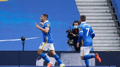 Brighton's Neal Maupay, left, celebrates after scoring the opening goal of the game from the penalty spot on Saturday. AP