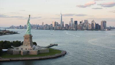 As Liberty Island draws closer, the full impact of the 305-foot Statue of Liberty makes itself known. Below, Ellis Island Immigration Museum. Jamie Grill / Tetra Images / Corbis; John Moore / Getty Images / AFP