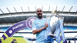 FILE PHOTO: Soccer Football - Premier League - Manchester City vs Huddersfield Town - Etihad Stadium, Manchester, Britain - May 6, 2018 Manchester City manager Pep Guardiola celebrates with the trophy after winning the Premier League title Action Images via Reuters/Carl Recine EDITORIAL USE ONLY. No use with unauthorized audio, video, data, fixture lists, club/league logos or "live" services. Online in-match use limited to 75 images, no video emulation. No use in betting, games or single club/league/player publications. Please contact your account representative for further details. / File Photo