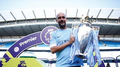FILE PHOTO: Soccer Football - Premier League - Manchester City vs Huddersfield Town - Etihad Stadium, Manchester, Britain - May 6, 2018 Manchester City manager Pep Guardiola celebrates with the trophy after winning the Premier League title Action Images via Reuters/Carl Recine EDITORIAL USE ONLY. No use with unauthorized audio, video, data, fixture lists, club/league logos or "live" services. Online in-match use limited to 75 images, no video emulation. No use in betting, games or single club/league/player publications. Please contact your account representative for further details. / File Photo