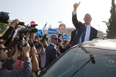Blue and White party leader Benny Gantz gives thumb up to his supporters after casting his vote. AP Photo