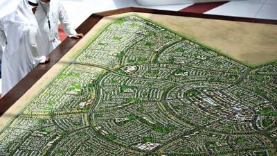 Visitors looks at a model of Musanada-South of Shamkha project by Abu Dhabi Urban Planning on the opening day of the Cityscape.