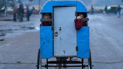 Schoolchildren travel to their school in a cycle rickshaw on a cold morning in the old quarters of Delhi. Ahmad Masood / Reuters