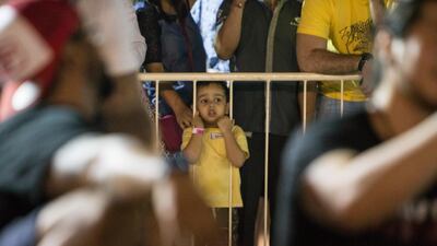 A child watches the contest at the World's Ultimate Deadlift, Burj Plaza, Dubai.