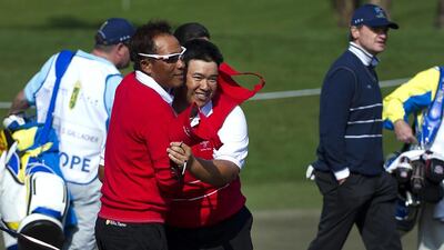 Thailand's Thongchai Jaidee, left, and Kiradech Aphibarnrat celebrate after beating Scotsmen Paul Lawrie and Stephen Gallacher on the first day of the Royal Trophy on Friday. AFP Photo