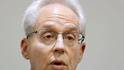 Former Nissan Motor executive Greg Kelly speaks during an interview in Tokyo. He was charged with underreporting the pay of his boss Carlos Ghosn but will be able to travel home to the US after a Tokyo court handed him a six-month suspended sentence. Kyodo News via AP