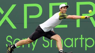 Andy Murray stretches to reach a shot from Grigor Dimitrov.