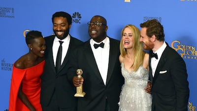 British director Steve McQueen (C) holds the Golden Globe for Best Motion Picture - Drama for '12 Years a Slave' as he poses with actress Lupita Nyong'o, Chiwetel Ejiofor, Sarah Paulson and Michael Fassbender in the press room. EPA