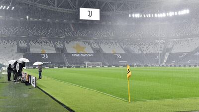 Staff linger on the touchline inside the Allianz Stadium as Juventus wait to discover if Napoli will turn up for their Serie A match. EPA