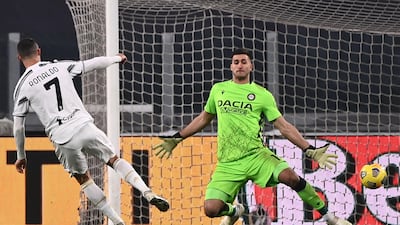 Cristiano Ronaldo finishes past Udinese's Argentine goalkeeper Juan Musso to score his second goal for Juve. AFP
