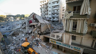 An excavator clears the rubble at the site of the Israeli air strike that targeted the branch. AFP