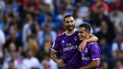 Karim Benzema, left, celebrates with his teammate Lucas Vazquez of Real Madrid after scoring his team’s second goal. David Ramos / Getty Images