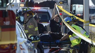 Emergency workers and police who rushed to the scene cordoned off the area as they helped victims and began their investigation. Adrian Wyld / The Canadian Press / AP Photo
