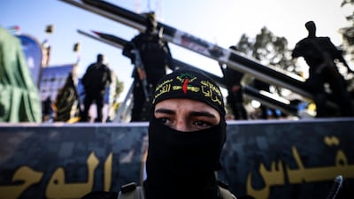 Fighters with the Saraya al-Quds Brigades, the armed wing of the Palestinian Islamic Jihad movement, parade with their weapons in the streets of Gaza City during a rally, on May 29, 2021, more than a week after a ceasefire brought an end to 11 days of hostilities between Israel and Hamas. Mahmud Hams / AFP