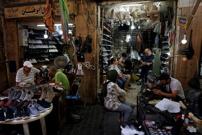 Workers repair shoes at a shop in Sidon in 2023. AFP