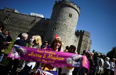 A woman holds up a commemorative scarf during rehearsals for the wedding of Britain's Prince Harry and Meghan Markle in Windsor. Clodagh Kilcoyne/ Reuters