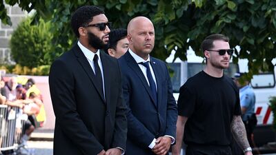 Liverpool manager, Arne Slot, centre, flanked by players Joe Gomez, left, and Alexis Mac Allister, arrive for the funerals of teammate Diogo Jota and his brother Andre Silva at Igreja Matriz de Gondomar. Getty Images