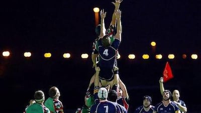 Jebel Ali Dragons, in blue, took over the top spot in the UAE's rugby echelon from Abu Dhabi Harlequins, in green, last season. With the national team's struggles, questions abound about pursuing Japan's model of corporate rugby as opposed to club rugby.