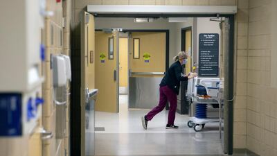 A nurse at Stormont Vail Health System pushes a hospital bed through hallways in Topeka, Kansas. AP