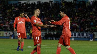 Real Madrid's Alvaro Odriozola, right, celebrates with his teammate Lucas Vazquez after scoring during the Spanish Copa del Rey match between Melilla and Real Madrid. AP Photo