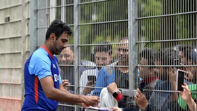 India's Ravichandran Ashwin signs autographs for fans after attending a training session at Edgbaston. AP