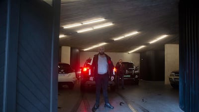 Men stand guard next to a vehicle as it arrives in the car park at the home of former Nissan Chairman Carlos Ghosn in Beirut. AP