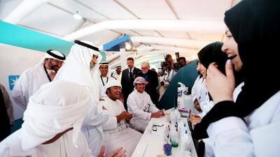 Sheikh Nahyan bin Mubarak Al Nahyan, Minister of Culture, Youth and Community Development, speaks with a group of youths at the Petroleum Institute's hands-on laboratory in the Young Adipec pavilion. Christopher Pike / The National