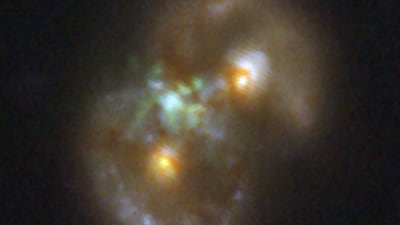 A black hole appears as a bright glow between two colliding galaxies. Photo: James Webb Space Telescope