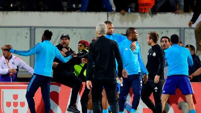 Marseille's defender Patrice Evra, centre, is in trouble for kicking a fan. Miguel Riopa / AFP