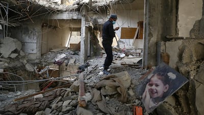 A worker searches for bodies still trapped under mounds of debris in Raqqa, Syria. REUTERS
