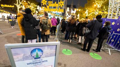 A sign warns visitors about Covid-19 entry protocols at the entrance to the 'Christkindlmarkt - Vienna's classic Christmas market. AFP