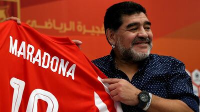 Diego Maradona holds up a Fujairah shirt bearing his name as he was officially introduced to the media as the club's new manager at a press conference in Fujairah on Sunday, May 14, 2017. Satish Kumar / The National