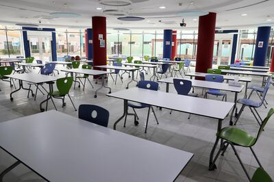 At the Jumeirah British School Jumeirah Park, tables in the canteen are placed two-metres apart and pupils are bringing lunch from home. Pawan Singh / The National
