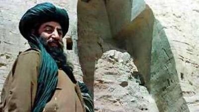 A member of the Taliban stands by the remnants of a destroyed sixth-century Buddha statue in Bamyan, central Afghanistan.