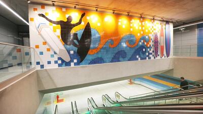A man descends an escalator in a station on the new Metro Line 4. The new link cost more than Dh11bn and It will help ferry passengers closer to the main Olympic Park. Mario Tama / Getty Images