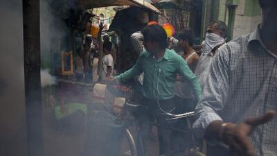 A municipality worker uses a machine to fog for mosquitoes at a neighbourhood in New Delhi, India. Despite efforts to stop mosquitoes from spreading dengue fever in New Delhi have failed to keep the city from its biggest outbreak in almost two decades: more than 10,190 registered cases, including 32 deaths. Saurabh Das/AP Photo