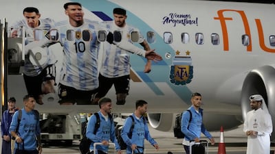 Angel Di Maria, left, and Lionel Messi, second right, of Argentina arrive with teammates at Hamad International Airport in Doha. AP Photo